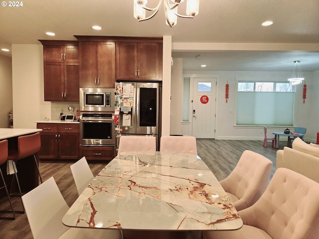 dining space with a notable chandelier and dark wood-type flooring