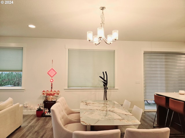 dining room featuring dark hardwood / wood-style floors and an inviting chandelier