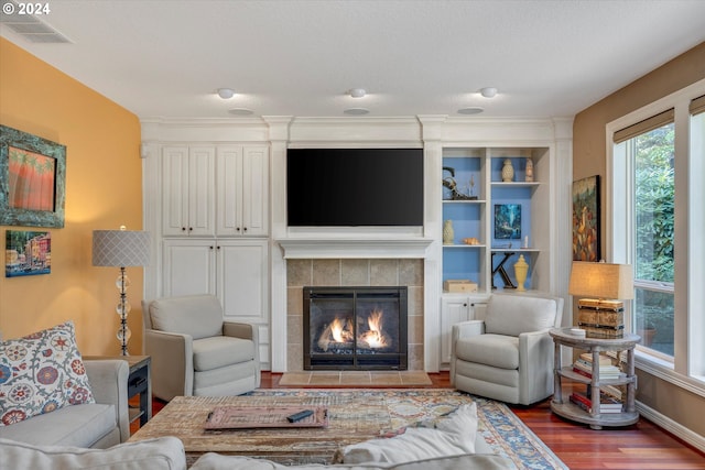 living room with hardwood / wood-style flooring and decorative columns