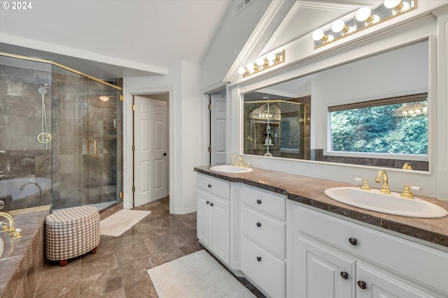 bathroom featuring vanity, a shower with door, and lofted ceiling