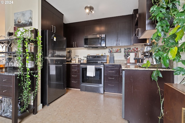 kitchen featuring stainless steel appliances, dark brown cabinetry, and sink