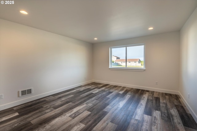 spare room featuring dark hardwood / wood-style flooring