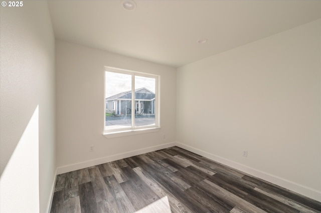 unfurnished room with dark hardwood / wood-style flooring