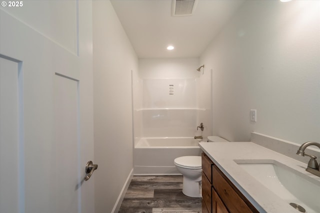 full bathroom with toilet, vanity, hardwood / wood-style floors, and shower / bathtub combination