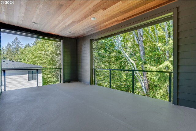 unfurnished sunroom featuring a healthy amount of sunlight and wood ceiling