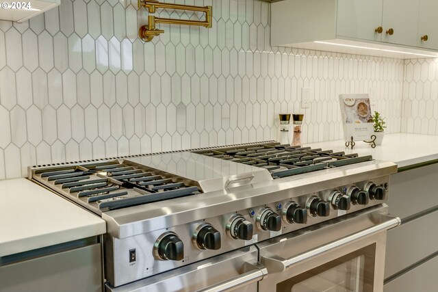 interior details with decorative backsplash and stainless steel stove