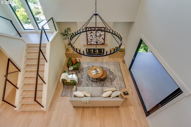 stairway with a towering ceiling and hardwood / wood-style flooring