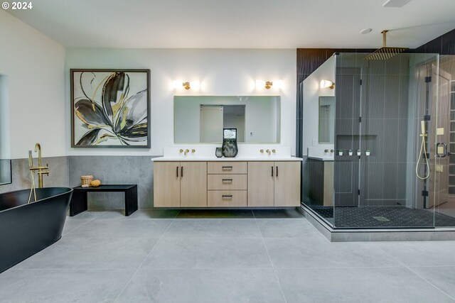 bathroom with tile patterned flooring, vanity, independent shower and bath, and tile walls