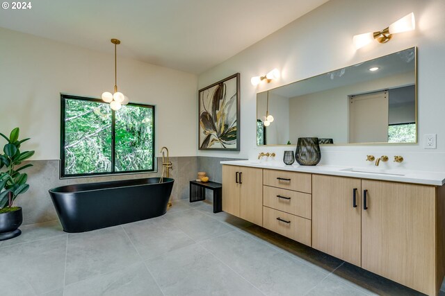 bathroom featuring tile patterned flooring, a bathtub, tile walls, and vanity