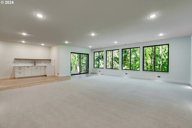 unfurnished living room featuring light wood-type flooring