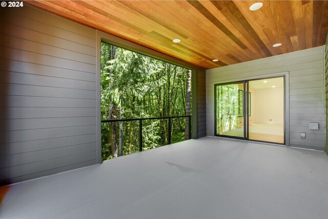 unfurnished sunroom with wooden ceiling