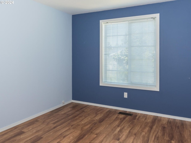 spare room with dark hardwood / wood-style flooring