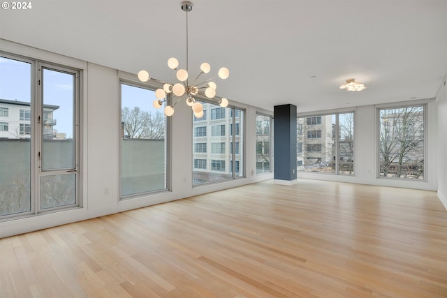 interior space featuring light hardwood / wood-style flooring and an inviting chandelier