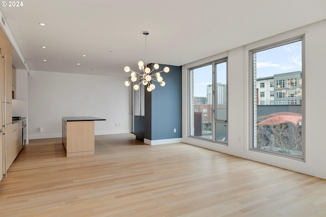 interior space featuring an inviting chandelier and light hardwood / wood-style floors