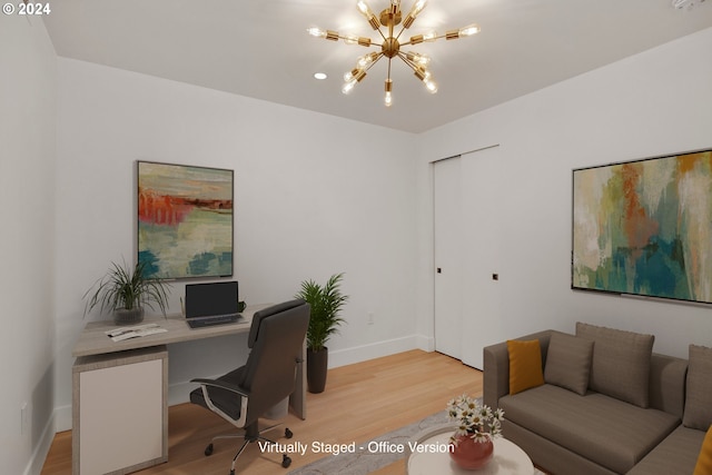 home office featuring a notable chandelier and light hardwood / wood-style floors