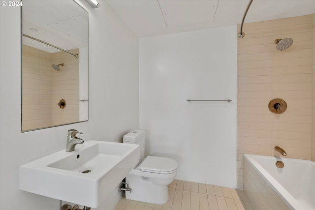 full bathroom featuring sink, tiled shower / bath combo, toilet, and tile patterned floors