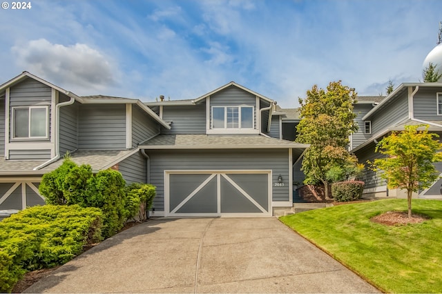 view of front of home featuring a garage and a front lawn