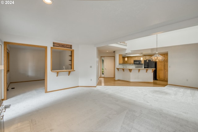 unfurnished living room with a textured ceiling and light colored carpet