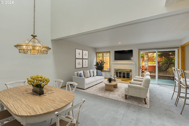 unfurnished living room featuring carpet, a chandelier, and a fireplace