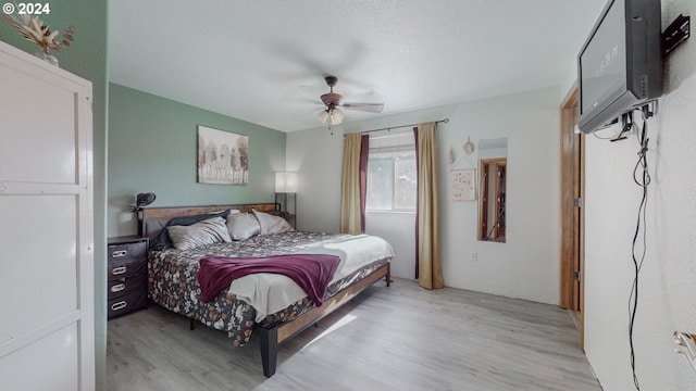 bedroom with ceiling fan and light hardwood / wood-style floors