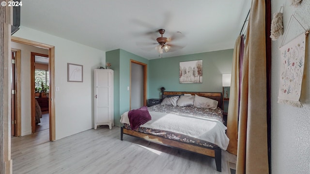 bedroom with ceiling fan and light hardwood / wood-style flooring