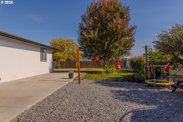 view of yard featuring a playground and a patio