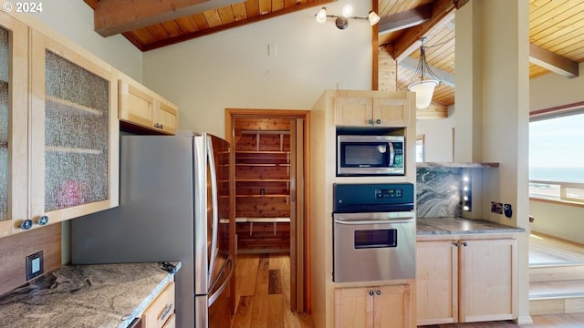 kitchen with pendant lighting, light hardwood / wood-style flooring, vaulted ceiling with beams, light brown cabinetry, and appliances with stainless steel finishes