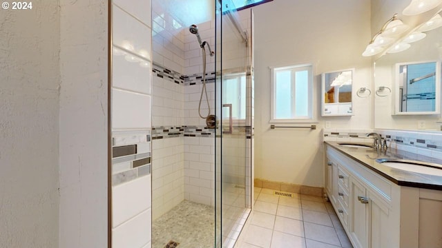 bathroom featuring tile patterned flooring, vanity, and a shower with shower door