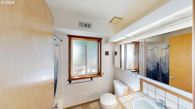 bathroom featuring vanity, toilet, and walk in shower