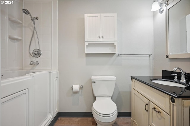 full bathroom with shower / bath combination, toilet, hardwood / wood-style flooring, and vanity