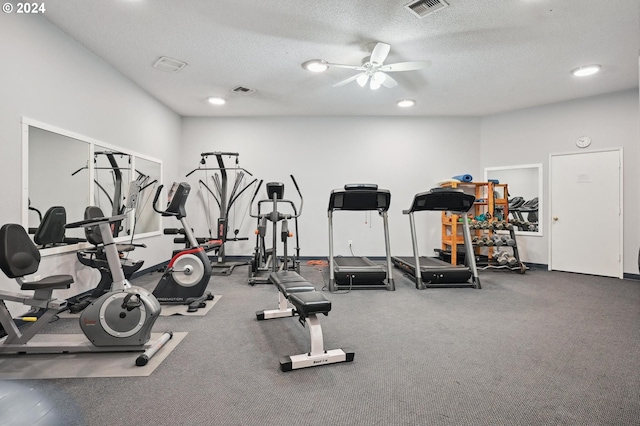 workout area featuring ceiling fan and a textured ceiling