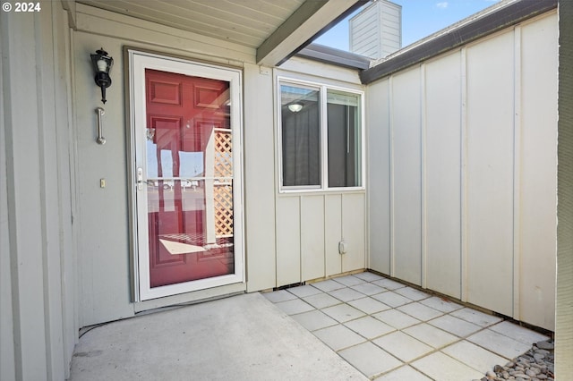 view of exterior entry with a patio area