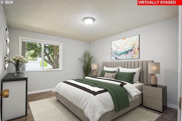 bedroom featuring a textured ceiling and hardwood / wood-style floors