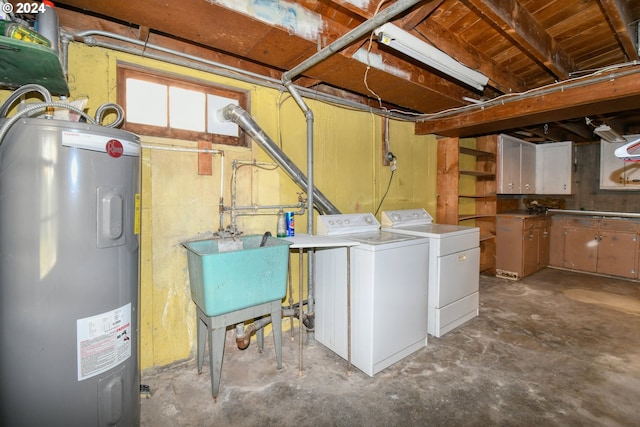 washroom with electric water heater, sink, and washing machine and clothes dryer