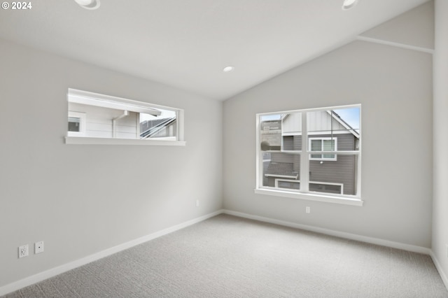 spare room with carpet and lofted ceiling