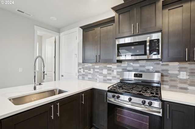 kitchen with decorative backsplash, sink, dark brown cabinetry, and stainless steel appliances