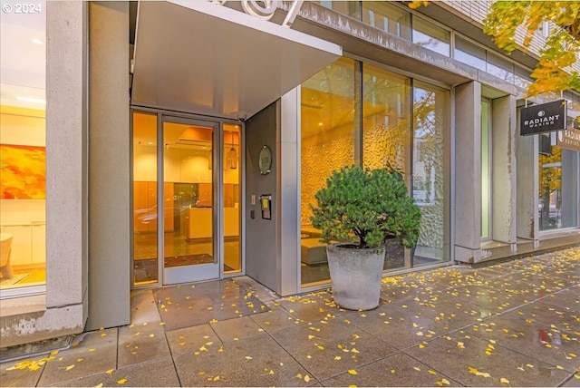 exterior entry at dusk featuring a patio area