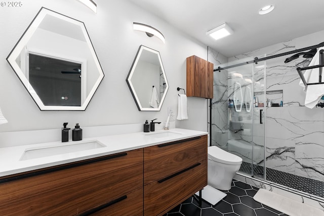 bathroom featuring vanity, toilet, and a shower with shower door