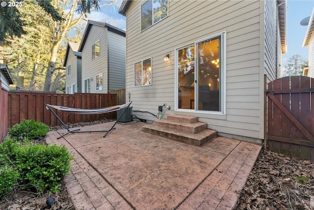 back of property featuring central AC unit and a patio area