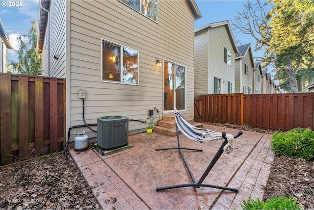 back of house with central air condition unit and a patio area