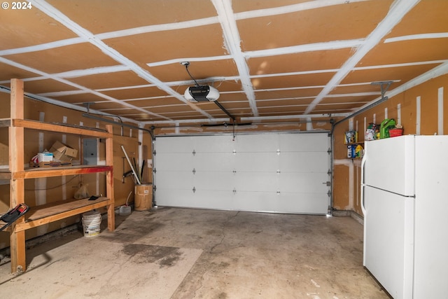 garage with a garage door opener and white refrigerator