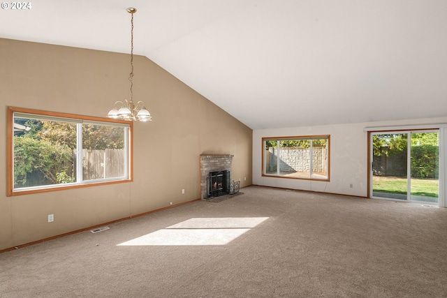 unfurnished living room featuring an inviting chandelier, carpet floors, and vaulted ceiling