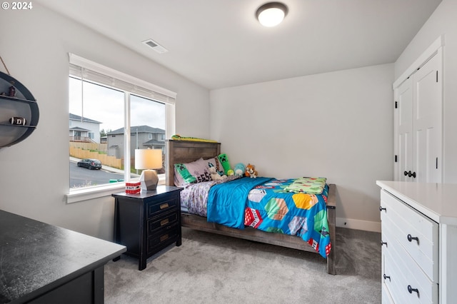 bedroom with light colored carpet, baseboards, and visible vents