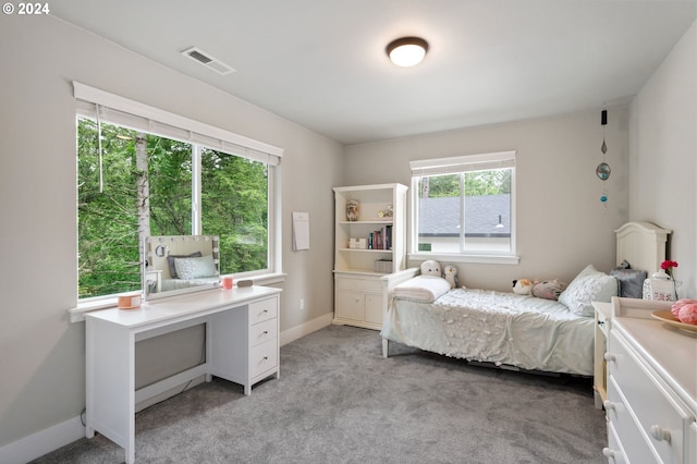 bedroom with visible vents, baseboards, and light carpet