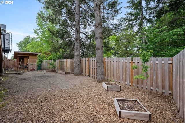 view of yard featuring a vegetable garden and a fenced backyard