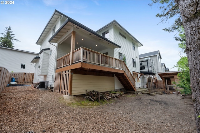 rear view of house featuring central AC unit, stairs, a wooden deck, and fence