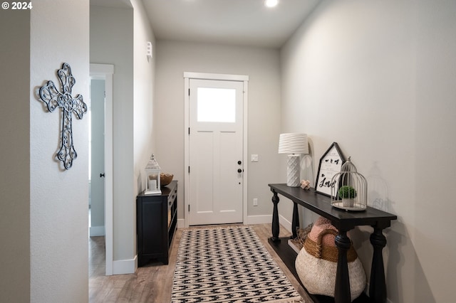 foyer entrance featuring light wood-style floors, baseboards, and recessed lighting