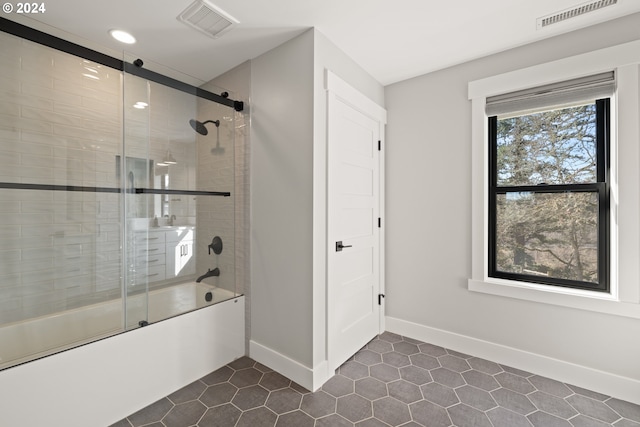 bathroom with shower / bath combination with glass door