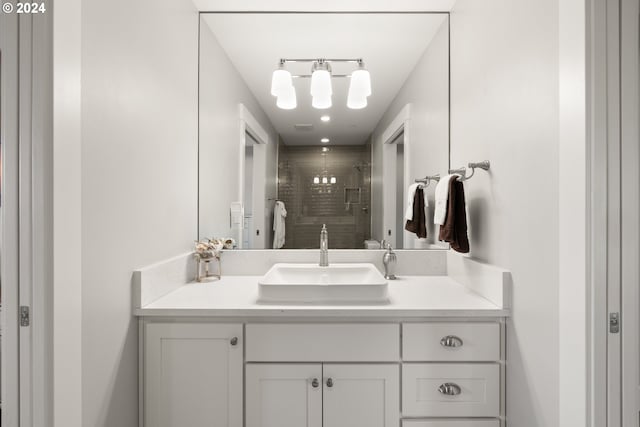 bathroom with vanity and tiled shower