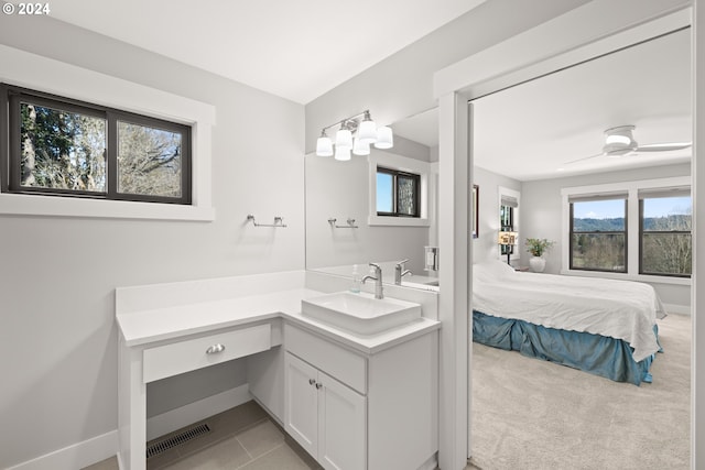 bathroom with vanity, tile patterned floors, and a healthy amount of sunlight